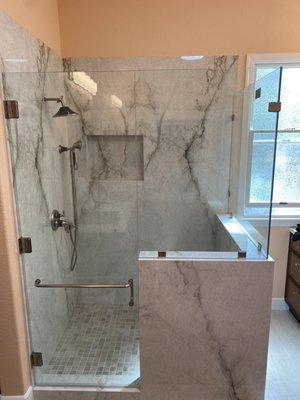 Frameless shower enclosure with a 90 degree corner