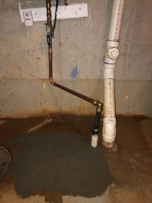 After - wet cement (immediately after repair completion). New sealed sleeve and copper connected line extension