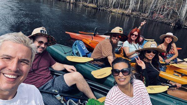 Friends connecting kayaks on the Santa Fe River, celebrating a birthday.