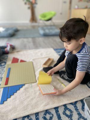 Working with the additional strip board Montessori material.