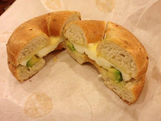 Egg white, avocado, cheese on onion dill bagel