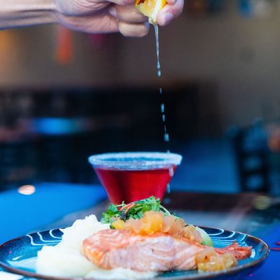 Grilled salmon topped with pineapple chutney, served with mashed potatoes and mixed greens