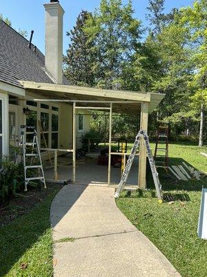 Start of a patio cover with large screen windows