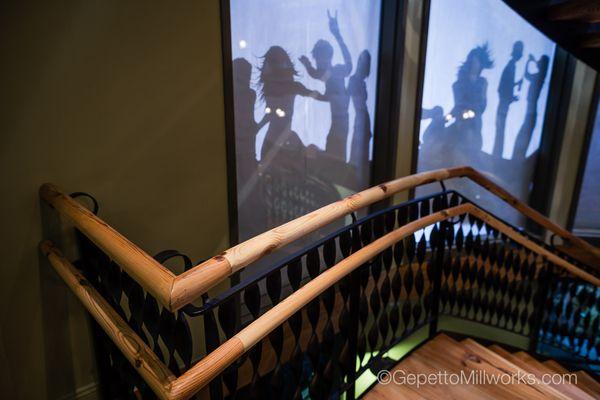 Two story spiral staircase design and built by Gepetto Millworks in the ladybird hat factory.