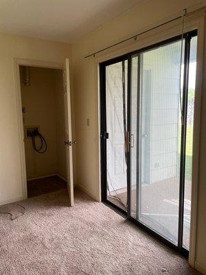 1BR w/d closet and patio door off of bedroom. Screen curtain shown not standard in all apartments