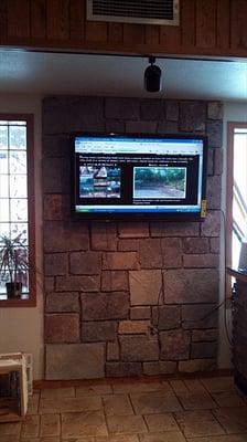 Real stone display behind showcase monitor in showroom