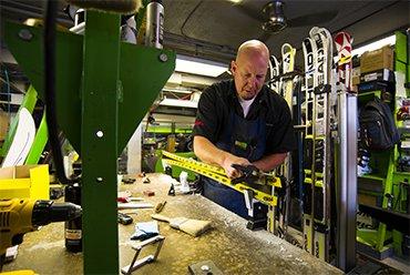 Andy B. doing what he does best, keeping your skis and boards running at their best!