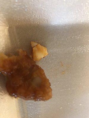 egg shell that was on piece of orange chicken.