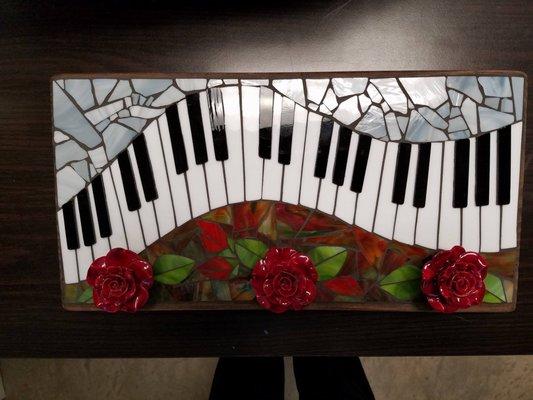 Function art. The roses are knobs for hanging keys, scarfs, etc. Stained glass on wood