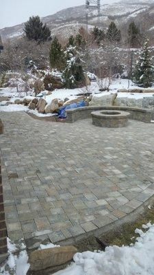 Patio with fire pit and sitting wall.