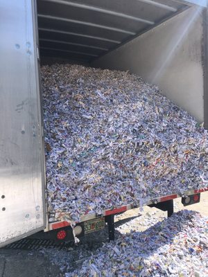 Shredded material being dumped at a secure recycling facility