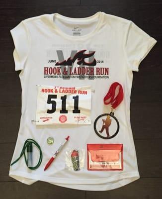 front of dri fit, top 20 finisher shirt, with bib, medal, and other race schwag