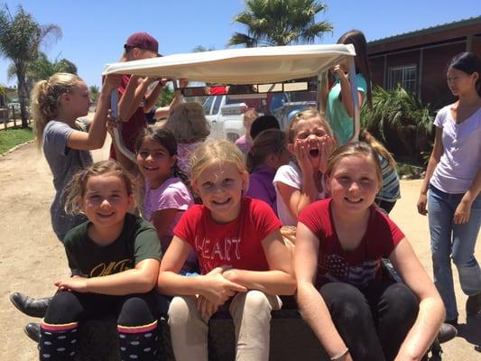 Margaret and camp kids going on a golf cart ride