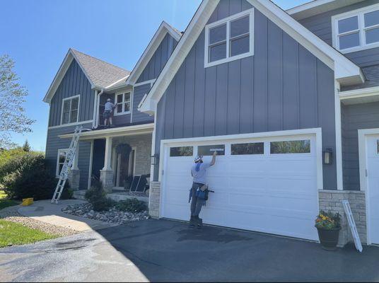 Joe cleaning garage windows.