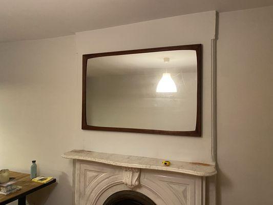 65lb mirror mounted on brick wall