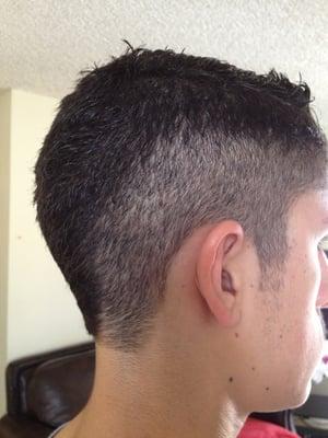 Mohawk-style cut with a 1 on the sides leading to the upper right/left of my neck. Just as I requested.