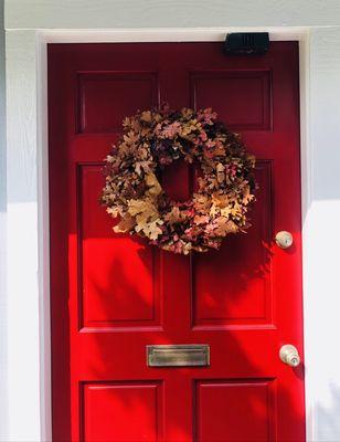 Our pretty new red door with fall wreath.