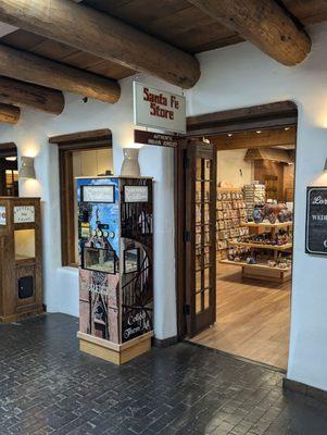 A penny smasher and a souvenir medallion machine in the hall outside