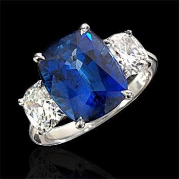 Cushion sapphire and diamond ring set in platinum.