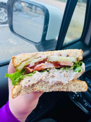 Build your own sandwich. Tuna salad, tomato, lettuce, red onion, and pickles on toasted wheat bread.