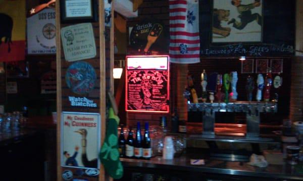 Portion of bar area with board noting various beers