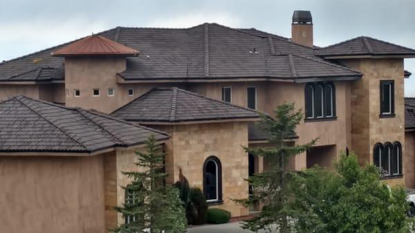 Tile reroof in Boise foothills using Boral Tile Roofing products and copper penny metal on round dormer.