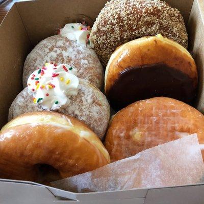 Small box of donuts: vanilla cream, honey glazed, jelly-filled, Boston cream, butternut.