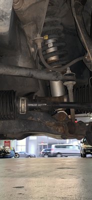 (BEFORE) Passenger outer tie rod showing too much thread and leaving none on driver's side, compromising alignment. See fix in AFTER photo.