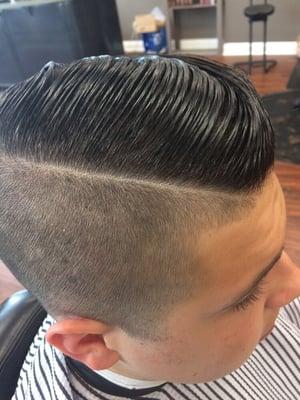 High fade comb-over with a hard part