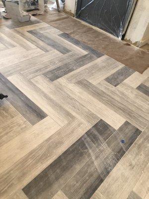 Herring Bone pattern of wood line tile! Just one of our projects!