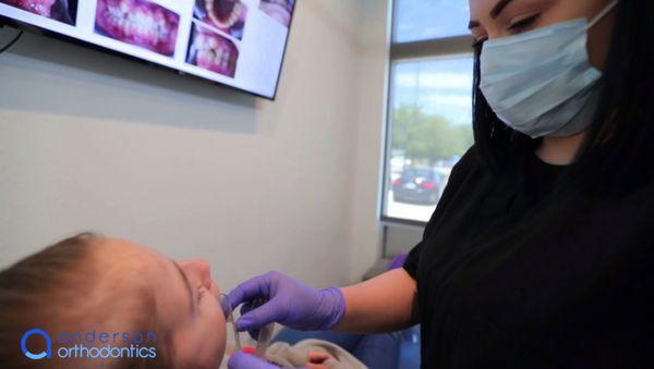 Dental hygienist with pediatric patient at Anderson Orthodontics