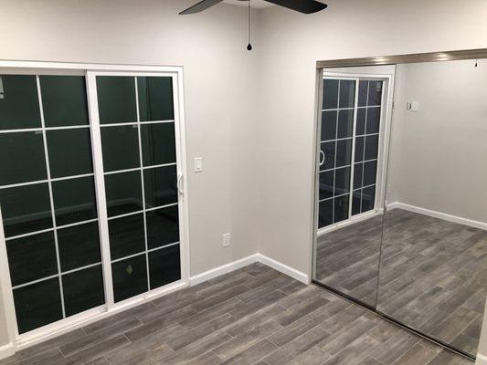 Bedroom with doors that lead to the back patio