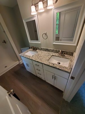 bathroom remodel. new flooring, granite sink