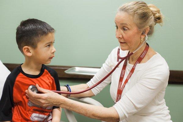 Family Healthcare provider during preschool check-up at the Cedar City clinic.