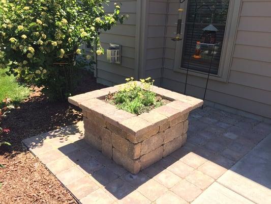 We built a custom patio with built in planter and fixed posts for bird feeders.