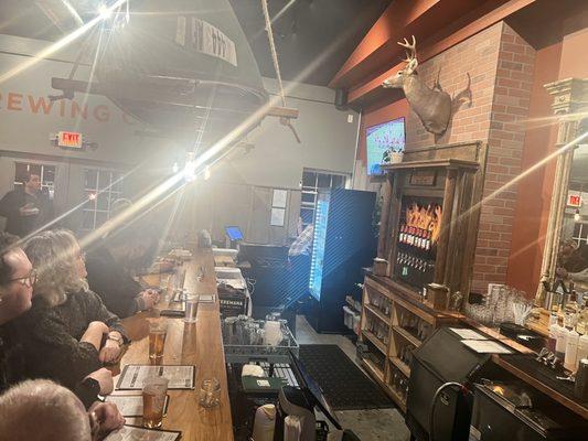 Bar area with Pale Fire beer on tap, a couple of TVs for sports watching