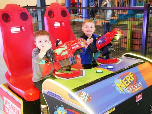 Little boys smiling in the Allegan Event arcade.