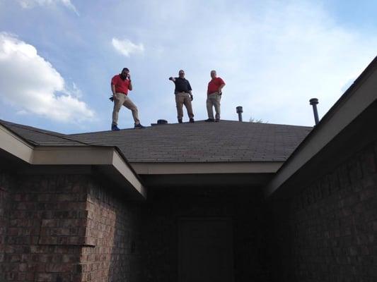 Team out in the field inspecting a roof.