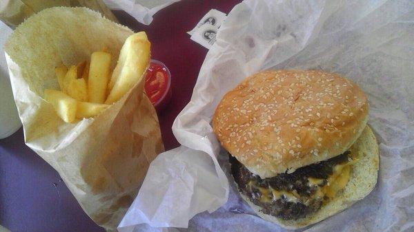 Classic greasy brown bag of fries and cheeseburger