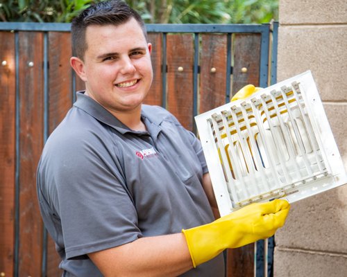 Devan cleaning supply grills on a duct clean!