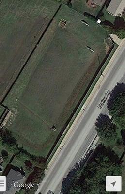 More recent google satellite image shows the fenced-in safety area between the park and the street.