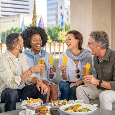 Friends enjoying lunch  on the rooftop at the Westgate Hotel and AquaVie Fitness + Wellness Center.