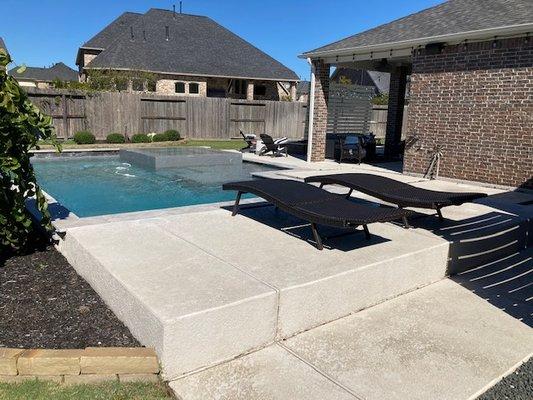 Hand brush scrubbed painted pool deck lounging platforms.