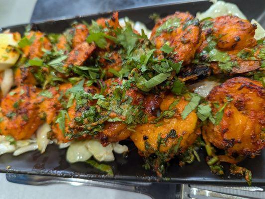 Tandoori Shrimp Jumbo shrimp marinated in a blend of tandoori spices and cooked to perfection in a tandoor.