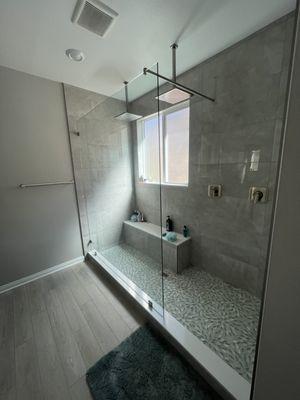 After: custom walk-in shower with double rainfall shower heads.