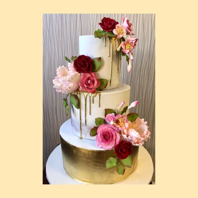 Beautiful cake for your perfect occasion! Pink and Gold flowers with gold dripping tiered cake.