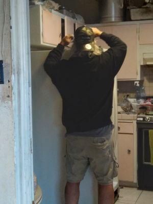 Delivery guy adjusting and fine-tuning the doors after installation and he did wear covid mask.