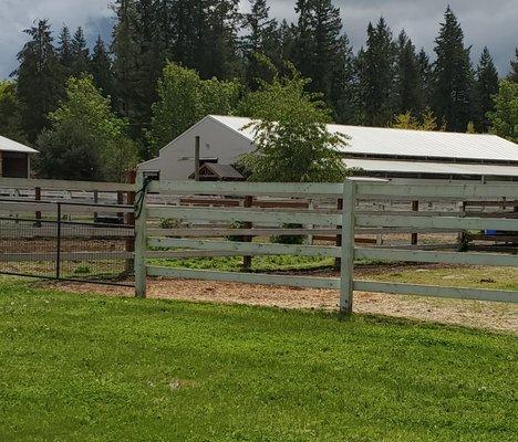 A view of our main barn which features a spacious indoor riding arena.