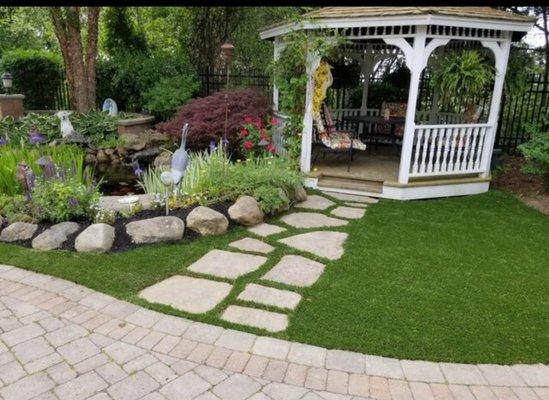 Here's a nice green outside with the green perfectly carved around the stone for a path way.