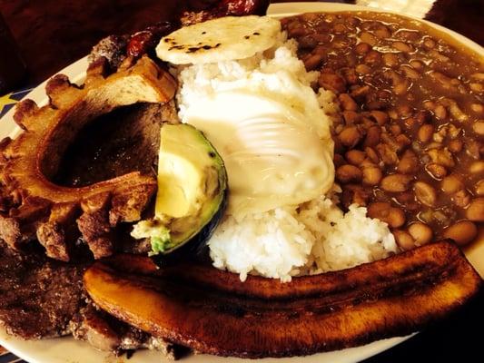 House special.. steak egg beans sausage rice avocado plantain and Latin goodness